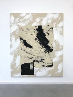 an abstract painting on display in a white walled room with concrete flooring and walls