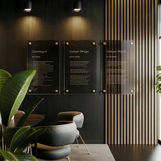 an office with black walls and wooden paneling, two chairs are facing the wall