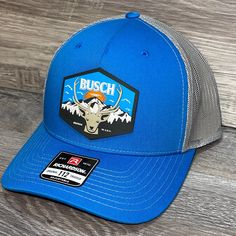 Our Pvc Patch Is A Waterproof, Rugged, And Clean Looking Design. You Can Bet That This Patch Will Look Vibrant For Years To Come. We Only Use The Highest Quality Products And Headwear. We Believe That Our Pvc Patches Beat Out Any Other Type Of Patch Offered On A Hat. Design: Busch Light Mountain Escape Hat: Richardson 112 Color: Blue/ Charcoal Structured, Six-Panel, Mid-Profile 60/40 Cotton/Polyester Adjustable Plastic Snapback Pre-Curved Contrast Stitched Visor Hat Size: 7 - 7 3/4 Nike Outdoor Baseball Cap With Curved Brim, Nike Curved Brim Baseball Cap For Outdoor, Nike Curved Bill Baseball Cap For Outdoor, Nike Snapback Baseball Cap For Outdoor, Nike Outdoor Baseball Snapback Hat, Nike Snapback Hat For Outdoor, Nike Outdoor Hats, Blue Baseball Cap With Visor For Outdoor Activities, Blue Snapback Trucker Hat For Outdoor Activities