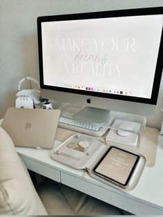 an apple computer sitting on top of a desk next to a keyboard and mouse with the words make your dreams are reality