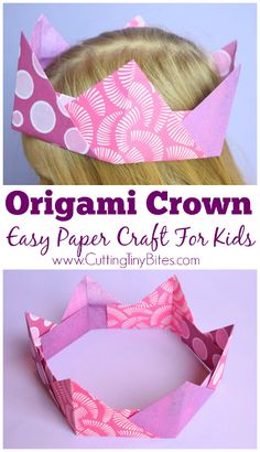 an origami crown made out of paper with pink and white designs on it