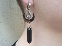 This devilishly witchy design features an obsidian crystal and a crescent moon pendant around an industrial washer. We love how the elements combine to make a design greater than the sum of its parts.  A limited 9 pair run for our Halloween collection. Sold as pairs.  Weight: 7g each (noticeable, medium weight)  Length: 7cm long  Clasp: 100% Hypoallergenic stainless steel huggies clasps.  - Our regular clasps are 10mm in diameter. We do offer larger clasps for those of you with stretched ears. P Mystical Nickel-free Black Jewelry, Mystical Black Nickel-free Jewelry, Mystical Black Metal Jewelry, Black Metal Jewelry With Moon Charm, Black Nickel-free Mystical Jewelry, Black Dangle Witchy Jewelry, Black Metal Witchy Earrings, Witchy Black Dangle Jewelry, Black Witchy Dangle Jewelry