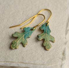 These green oak leaf earrings are brass charms with some amazing detail, which have been carefully treated, painted and varnished to bring out beautiful tones and depth of colour and to show the incredible veining and other details of the metal.  These are coloured a beautiful, delicate and multi toned turquoise colour.   They are handmade in our Edinburgh studio and no two pairs are quite the same!  Each leaf is 15mm long (very tiny and delicate) and are designed to hang just below the earlobe. Long Turquoise Earrings, Oak Leaf Earrings, Boho Turquoise, Silk Purse, Earrings Art, Turquoise Boho, Oak Leaf, Brass Charms