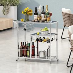 a bar cart filled with bottles and wine glasses on top of a white tiled floor