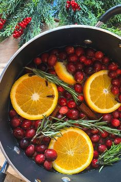 oranges and cranberries are being cooked in a pan