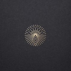 a black background with gold lines and a sunburst in the middle on it