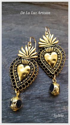 "Sylvie Earrings Materials:  10k Gold plated hooks, 22k gold plated Lava Rock, Silver plated heart or Gold plated heart Length:  2.75\" Available in either silver or gold milagro flaming hearts, the Sylvie earrings are inspired by Mexican Folk Art.  I've added gorgeously gilded Lava Rocks & 10k gold hooks.   Your earrings will be very similar to the ones shown, but due to natural variation your set will be uniquely one of a kind. All orders over $35 ship free! Experience the Luxury of Handcrafte Gold Plated Heart Earrings For Wedding, Bohemian Pierced Jewelry For Anniversary, Bohemian Heart Earrings For Wedding, Bohemian Heart-shaped Wedding Earrings, Ornate Gold Earrings With French Hook, Bohemian Heart-shaped Jewelry For Parties, Heart-shaped Bohemian Party Jewelry, Bohemian Heart-shaped Party Jewelry, Gold Drop Earrings For Valentine's Day