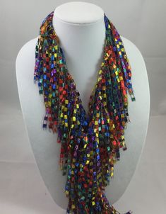 A beautiful and unique handmade accessory that shimmers and portrays a beaded look! Each Infinity Scarf Necklace is handmade and can be worn multiple ways. Item is lite weight and is available in many stunning great colors. Comes packaged in an organza bag. A great gift item. Each Infinity Scarf Necklace is a continuous loop approximately 66 inches in circumference and is made of 97% Nylon and 3% Lurex. Hand wash in cold water and lay flat to dry. Each item is made by hand and slight variations Party Lariat Necklaces With Beaded Chain, Multi-strand Beaded Chain Party Jewelry, Multi-strand Beaded Chain Jewelry For Party, Party Long Beaded Chain Necklaces, Party Long Beaded Necklaces, Unique Beaded Necklaces For Party, Adjustable Beaded Necklace With Large Beads For Party, Adjustable Beaded Chain Necklace For Party, Adjustable Beaded Necklace For Party