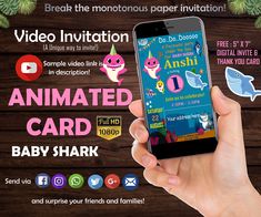 someone is holding up their phone to show the animated card for baby shark birthday party