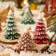 small christmas trees sitting on top of snow covered ground