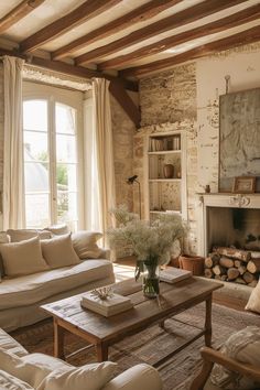 a living room filled with furniture and a fire place in front of a stone wall