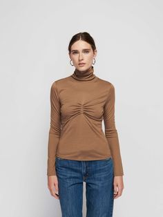 The turtleneck that's made for romance. Featuring a flattering front shirring (for a chic touch) and a foldable neckline. Pairs well with date night… (This one comes in Teddy.) | Eris Turtleneck Top in Teddy | Ethical Essentials Chic Fitted Turtleneck Top, Chic High Neck Ruched Tops, Chic Ruched High Neck Tops, Chic Spring Turtleneck, Chic Fall Tops With Ruched Detail, Chic Ruched Tops For Fall, Nation Ltd, Turtleneck Top, Turtle Neck Top