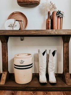 two white boots sitting on top of a wooden shelf next to a basket and other items