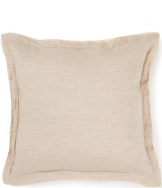 the linen pillow is beige and has a ruffled edge