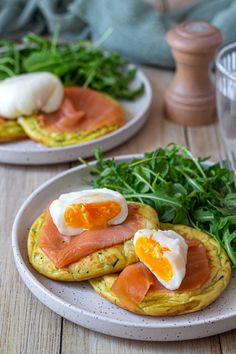 two plates with eggs and salmon on them