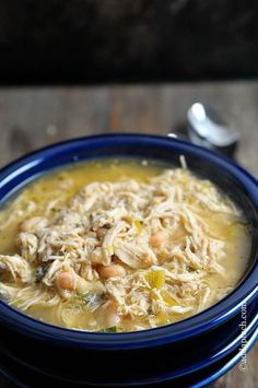 a close up of a bowl of food with broth and meats in it