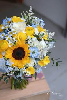 a vase filled with yellow and white flowers