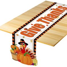 a wooden table with a thanksgiving sign on it