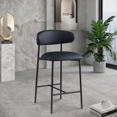 a black bar stool sitting on top of a carpeted floor next to a potted plant