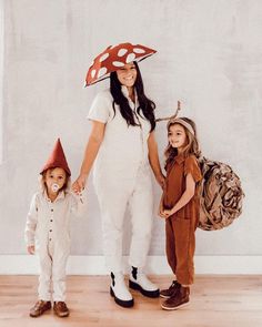 a woman and two children dressed up as gnomes, one with a mushroom hat