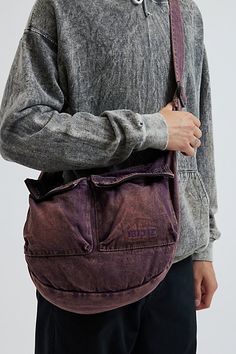 Acid wash crossbody bag by UO's own BDG label. Durable cotton canvas bag with zippered pockets and an adjustable webbing shoulder strap. Urban Outfitters exclusive. Features Crossbody bag from BDG Acid wash cotton canvas Utility style pockets Adjustable webbing strap UO exclusive Content + Care 100% Cotton Spot clean Imported Size Dimensions: 12" h x 16" l x 4" d | BDG Acid Wash Crossbody Bag in Washed Purple, Men's at Urban Outfitters Streetwear Cotton Bags With Pockets, Cotton Streetwear Bags With Pockets, Streetwear Canvas Bags With Pockets, Large Capacity Canvas Shoulder Bag For Streetwear, Cotton Hobo Canvas Bag For Everyday Use, Vintage Waxed Canvas Bag With Pockets, Cotton Bags With Functional Pockets For Everyday, Utility Cotton Bag With Zipper Pocket, Vintage Cotton Crossbody Bag