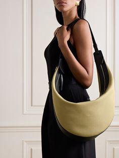 KHAITE's bag is an enduringly chic style you'll carry for years to come. Made from durable canvas, it has leather trims stamped with the brand's logo and a comfortable shoulder strap. Inside you'll find plenty of space for your wallet, phone and keys plus a tablet, water bottle and sunglasses. Ferragamo Bag, Denim Flats, Flat Dress Shoes, Dress Flats, Boot Pumps, Canvas Shoulder Bag, Bag Dress, Ski Wear, Beauty Accessories