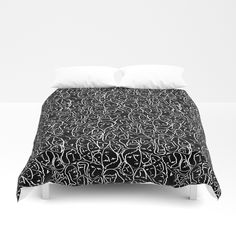 a bed with black and white designs on it