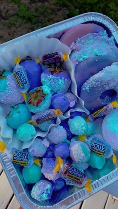 an ice cream container filled with blue and purple candies