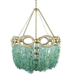 a chandelier with green glass beads hanging from the ceiling