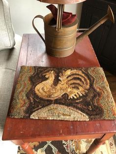 a coffee table with a rug on it and a watering can sitting next to it