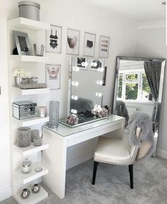 a white desk with a mirror and some pictures on the wall