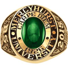 a ring with an oval green stone in the center and two gold lettering on it