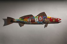 a fish made out of magazines floating in the air