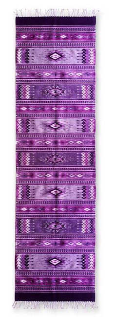 a purple and black rug with fringes on the bottom, in front of a white background