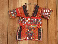 nice choli blouse as always small 12 inch arm 13 across chest 18 inches long I collected my cholis over 30 years ago as I always loved them even if I could never wear them. One has to be small chested - small everywhere to actually wear without alterations. the work - the mirrors and metal pieces - the colors - what is not to love . Since I have sold these at many dance festivals for decades - most gals will alter them. this Etsy site is new to me so I think people collect items here also for de Bollywood Festive Blouse For Rituals, Traditional Blouse For Navratri Rituals, Unstitched Choli Blouse For Festive Rituals, Traditional Festive Blouse For Rituals, Bohemian Blouse For Festive Transitional Season, Bohemian Blouse With Motifs For Transitional Season, Bohemian Unstitched Blouse Tops For Navratri, Bohemian Tops With Pallu For Festivals, Bohemian Unstitched Blouse For Navratri