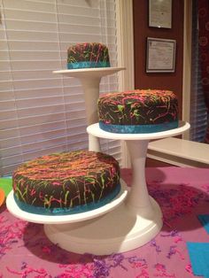 two cakes sitting on top of white pedestals