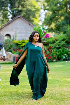 The Mace long green gown is the perfect embodiment of class, style, and elegance.  This one-shoulder detail adds just enough flare for you to appear stylishly unique. This Emerald Green One-Shoulder Formal Gown is the epitome of timeless beauty and modern sophistication. Perfect for formal events, proms, weddings, or any special occasion where you want to shine. The luxurious fabric and stunning color will make you feel like royalty. The gown features:  I. One-Shoulder Design: The asymmetrical neckline adds a touch of modern elegance and sophistication, making you stand out in any crowd. II. Luxurious Fabric: Crafted from high-quality, Polyester fabric that drapes beautifully and feels luxurious against the skin. III. Flattering Fit: The flowing nature of the design creates a timeless silh Embellished Floor-length Green Kaftan, Glamorous Green V-neck Maxi Dress, Emerald Green Gown, Dress Emerald Green, Long Cape, Green Gown, Cape Sleeves, Floor Length Gown, Black Tie Event