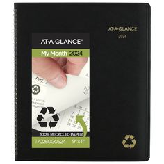 a notebook with a hand on top of it and the words, at - a - glance