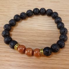 The bracelet contains two stones that are vital to our wellbeing: Goldstone and Lava Stone. The sparkles of Goldstone are symbolic of light that can always be found in the darkness. It deflects unwanted energies and is highly regarded in the spirit realm as a protective mineral. Lava Stone is a grounding stone that strengthens the connection to Mother Earth. A calming stone, it is instrumental in dissipating anger. It promotes positive changes where needed in behavioral issues. Our Brown Goldsto Spirit Realm, Positive Changes, In The Darkness, Calming Stones, Diffuser Bracelets, Real Stone, Lava Stone, The Darkness, Friendship Gifts