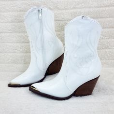 Faux Leather Upper Western Style Smooth Faux Leather Upper With Western Design Stitching Metal Toe Guard Cushioned Insole And Inside Zipper For Easy On/Off. Heel Height: 3" (Approx) Runs Tts White Mid-calf Boots With Stacked Heel For Fall, White High Heel Faux Leather Boots, White Martin Boots For Spring, White Faux Leather High Heeled Boots, White High Heel Mid-calf Boots Medium Width, White Pointed Toe Martin Boots For Winter, Trendy Faux Leather Wedge Boots For Spring, White Faux Leather Heeled Boots For Winter, White High Heel Wedge Boots For Spring