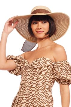 This brown and natural beige braided sun hat with bow adds instant style and functionality to your warm weather look! Brown Boater Hat With Upf 50+ For Vacation, Chic Straw Boater Hat With Upf 50+, Chic Straw Boater Hat For Garden Party, Chic Straw Sun Hat For Garden Party, Chic Straw Hat For Picnic, Brown Panama Hat With Uv Protection For Vacation, Brown Summer Hat With Upf 50+, Brown Panama Hat With Upf 50+ For Vacation, Brown Brimmed Sun Hat With Uv Protection