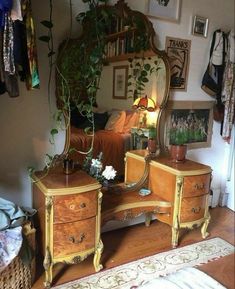 a bedroom with a dresser, mirror and plants on the wall next to an area rug