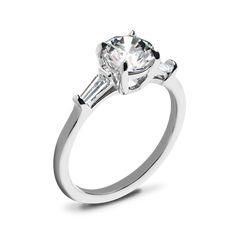 a white gold engagement ring with two baguets on the side and an accent diamond