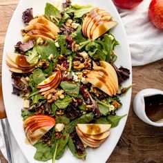 an apple and walnut salad on a white plate