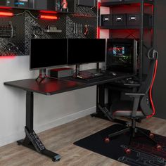 two computer monitors sitting on top of a desk next to a keyboard and monitor screen