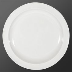 an empty white plate on a black background