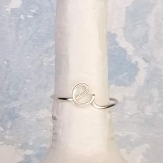 This dainty, personalized E initial ring is adjustable and the perfect way to show some self love, wear as friendship rings with your best buds, give to your bridesmaids as a thoughtful gift they will treasure forever, or to your girlfriend to keep you in her thoughts! Wrapped by hand using nickel free, non tarnish, high quality wire, this letter ring is custom made JUST FOR YOU!-----------------------------------------------MATERIAL: The wire is made out of high quality non-tarnish coated coppe Adjustable Initials Stackable Rings For Everyday, Everyday Adjustable Stackable Rings With Initials, Adjustable Hypoallergenic Initial Ring For Everyday, Adjustable Dainty Initial Ring For Promise, Minimalist Adjustable Initial Ring, Hypoallergenic, Minimalist Adjustable Hypoallergenic Initial Ring, Adjustable Minimalist Hypoallergenic Initial Ring, Dainty Adjustable Hypoallergenic Initial Ring, Custom Name Adjustable Initial Ring For Promise