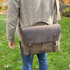 a man carrying a brown leather messenger bag