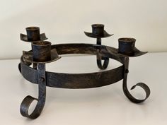 a metal candle holder sitting on top of a table