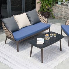 two chairs and a coffee table on a patio